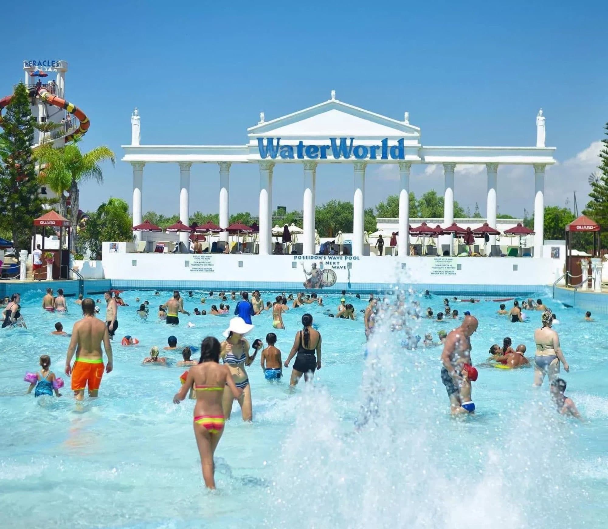 Crowd of visitors in the wave pool in front of WaterWorld's Greek-columned entrance